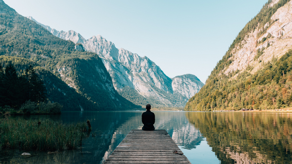 a man Drinking from Water Bottle on a dock
